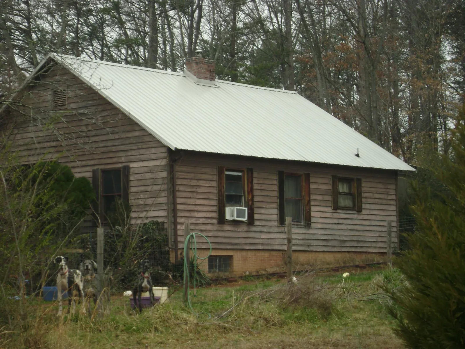 White metal roof on an old wood sided farmhouse, from a Metal Roof Installation job in Thomaston